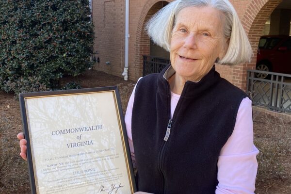 Leslie Bowie holding her framed certificate.
